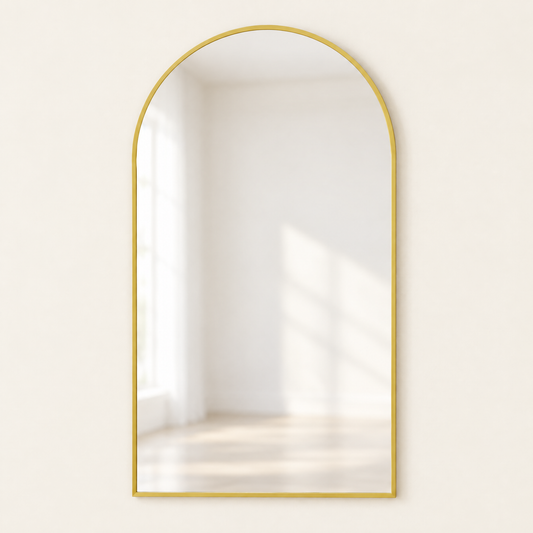 Arched metal frame wall mirror in champagne gold