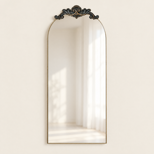 Tall arched wall mirror with slim dark frame and ornate crest